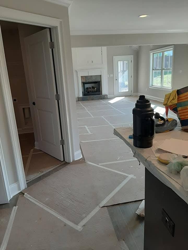 A living room is being painted in a new home.