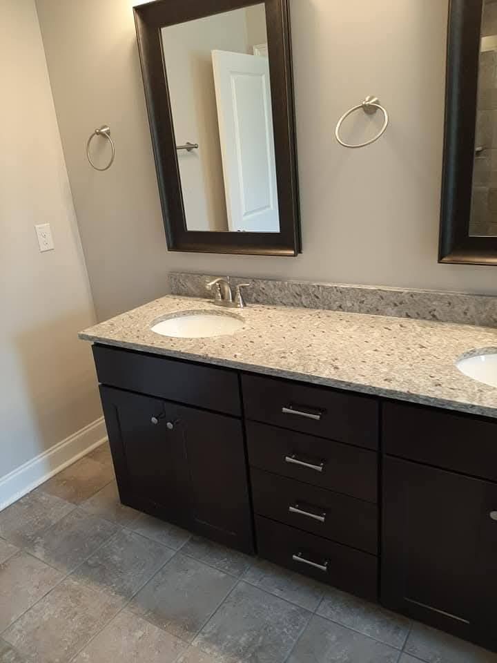 A bathroom with two sinks and two mirrors.