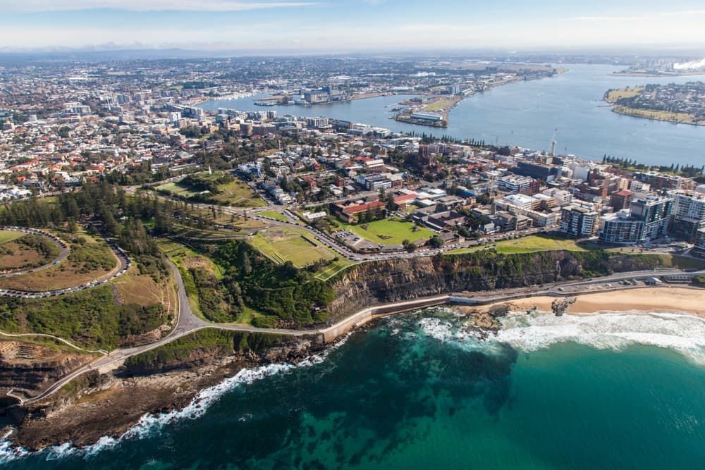 An Aerial View of A City Next to A Body of Water — Lite Moves Furniture Removals In Bonville, NSW