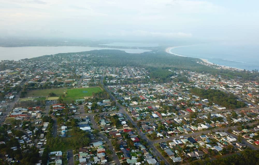An Aerial View of A City with A Lake in The Background — Lite Moves Furniture Removals In Bonville, NSW