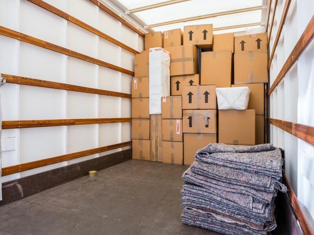 Interior of a Moving Truck Packed With Cardboard Boxes — Lite Moves Furniture Removals In Sydney, NSW