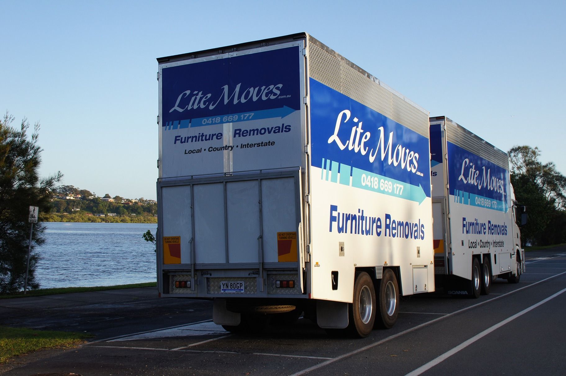 Two Men Are Loading a Mattress Into a Van — Lite Moves Furniture Removals In Coffs Harbour, NSW