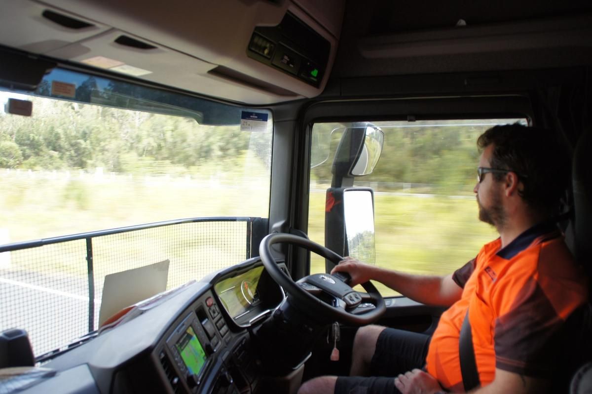 Man Driving a Truck on a Road With Trees in the Background — Lite Moves Furniture Removals In Sydney, NSW