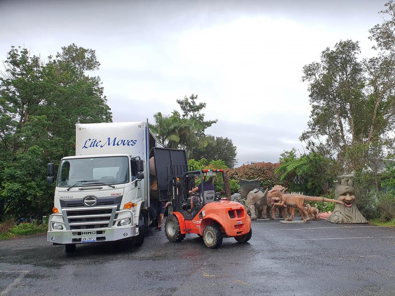 Orange Forklift loading onto truck - Lite Moves Furniture Removals In Bonville, NSW