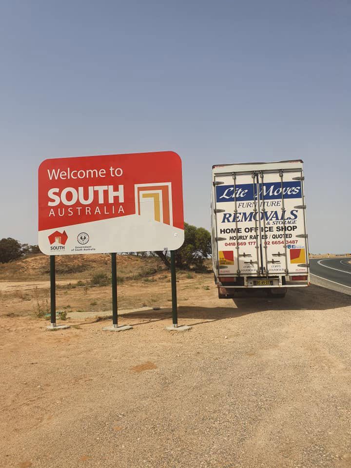 Lite Moves Truck Parked On The Side Of The Road With Welcome South Australia Sign — Lite Moves Furniture Removals In Bonville, NSW
