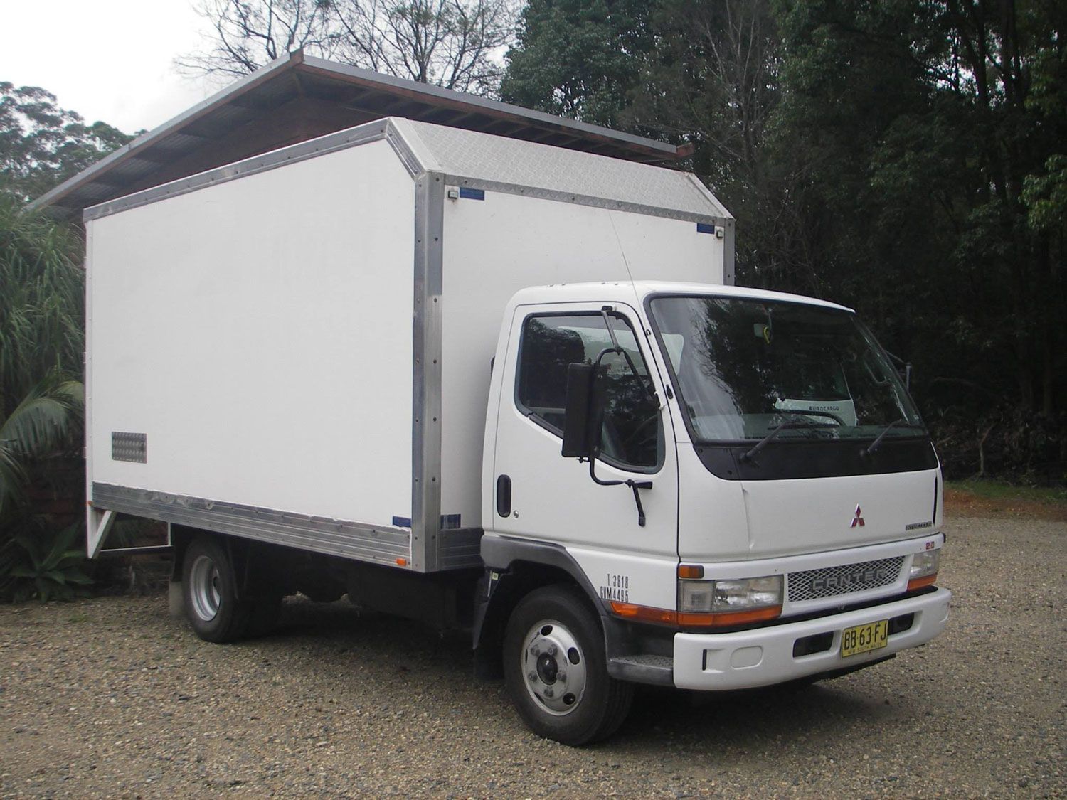 White Truck With a Roof is Parked in a Gravel Lot — Lite Moves Furniture Removals In Sunshine Coast, NSW