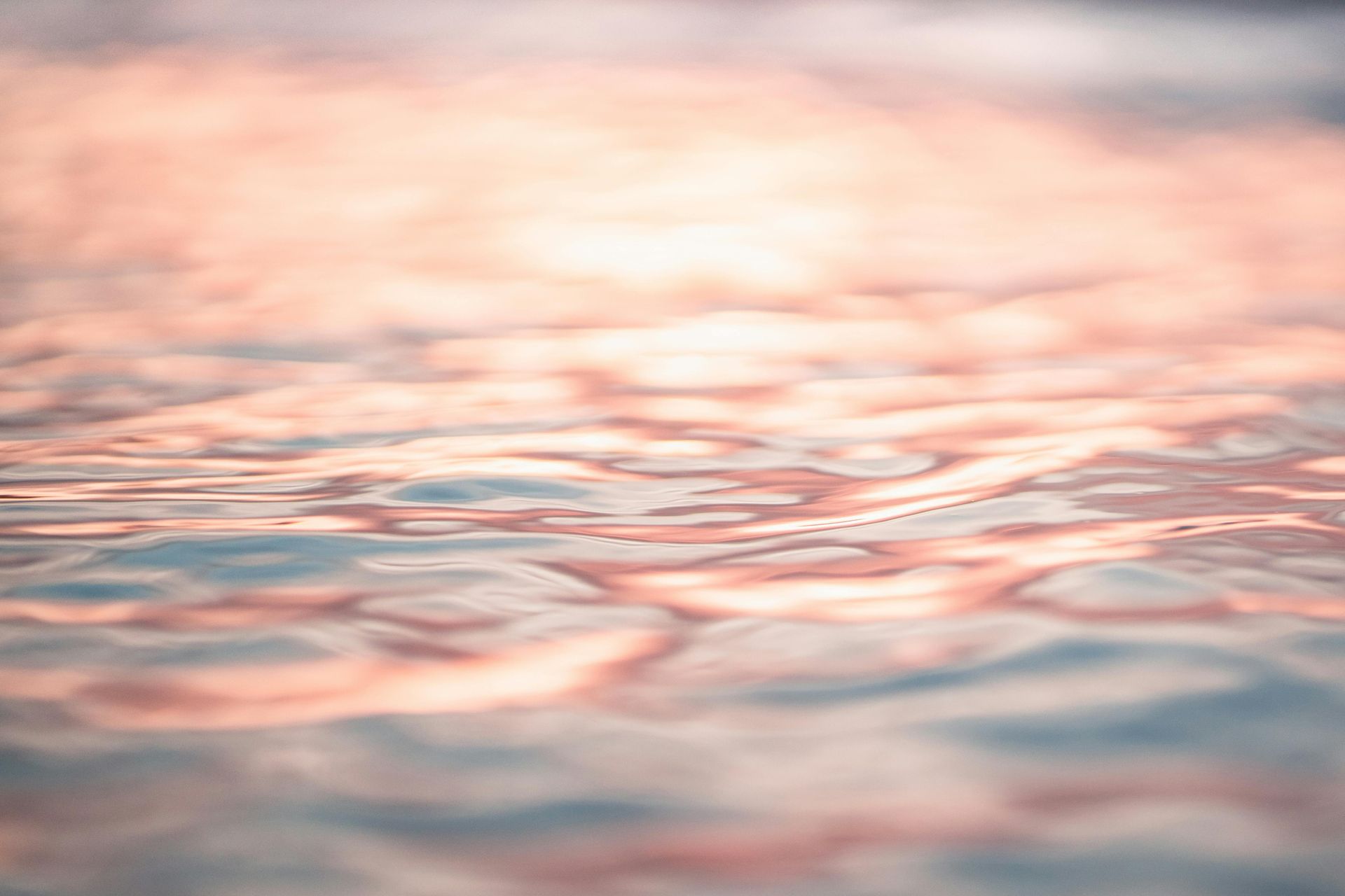 A close up of a body of water at sunset.