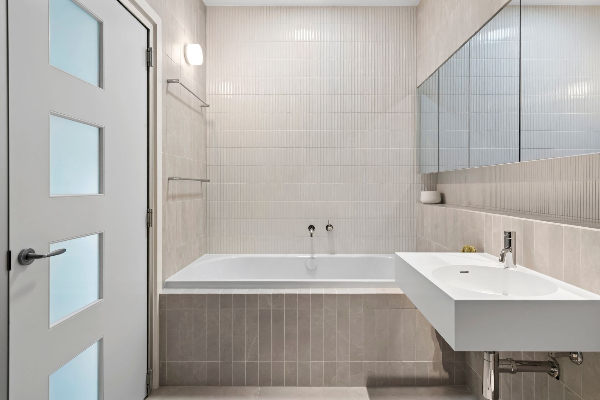 Modern bathroom with white walls, a tub, and a white floating sink — PK4 Projects in Port Macquarie, NSW