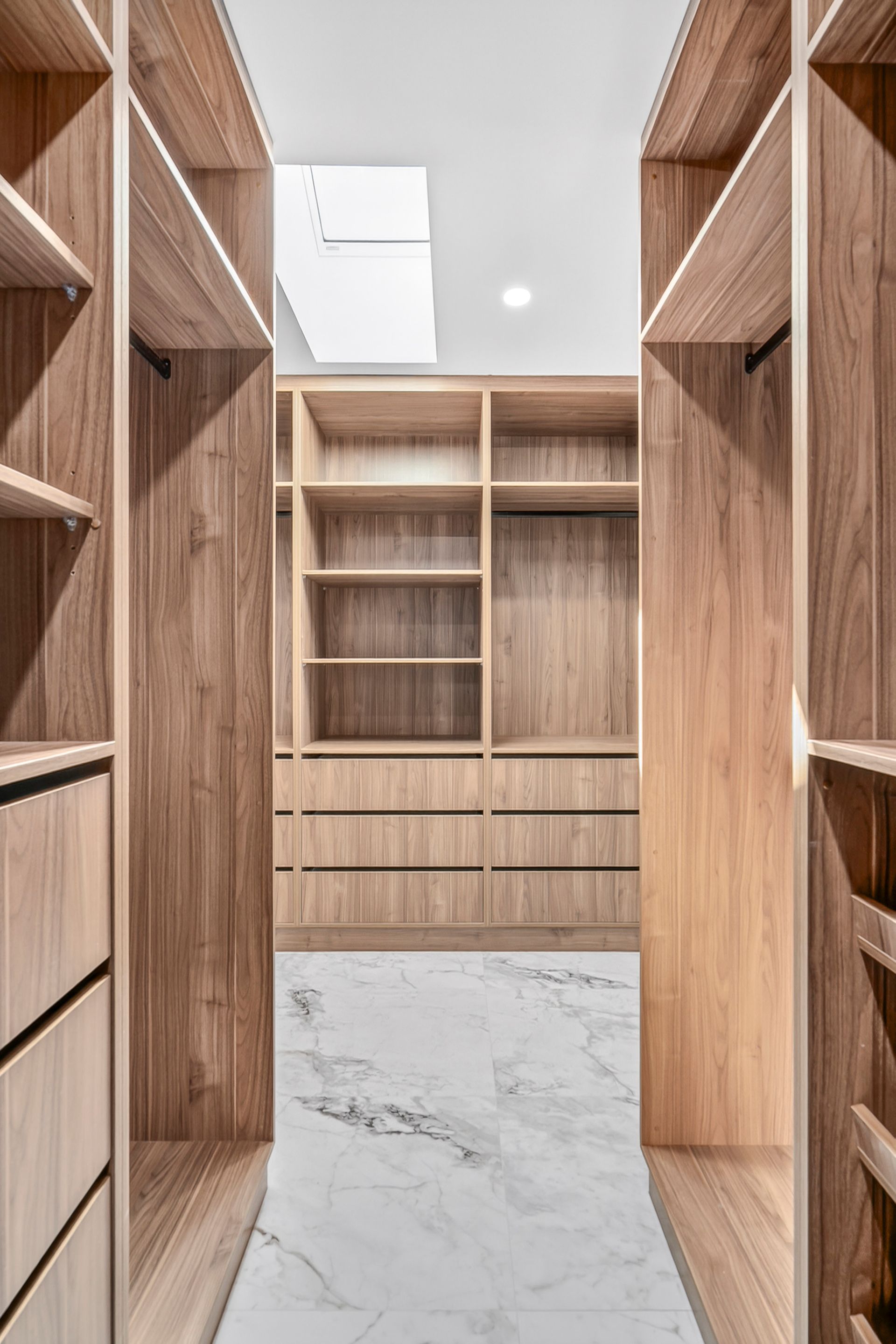 Wooden walk-in closet with shelves and drawers, marble flooring, and natural light — PK4 Projects in Port Macquarie, NSW