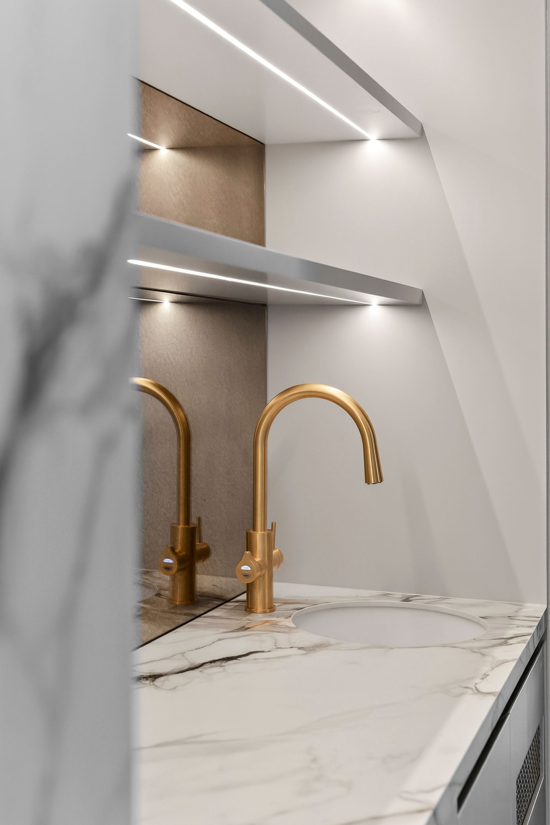 Gold kitchen faucet on marble countertop with recessed lighting — PK4 Projects in Port Macquarie, NSW