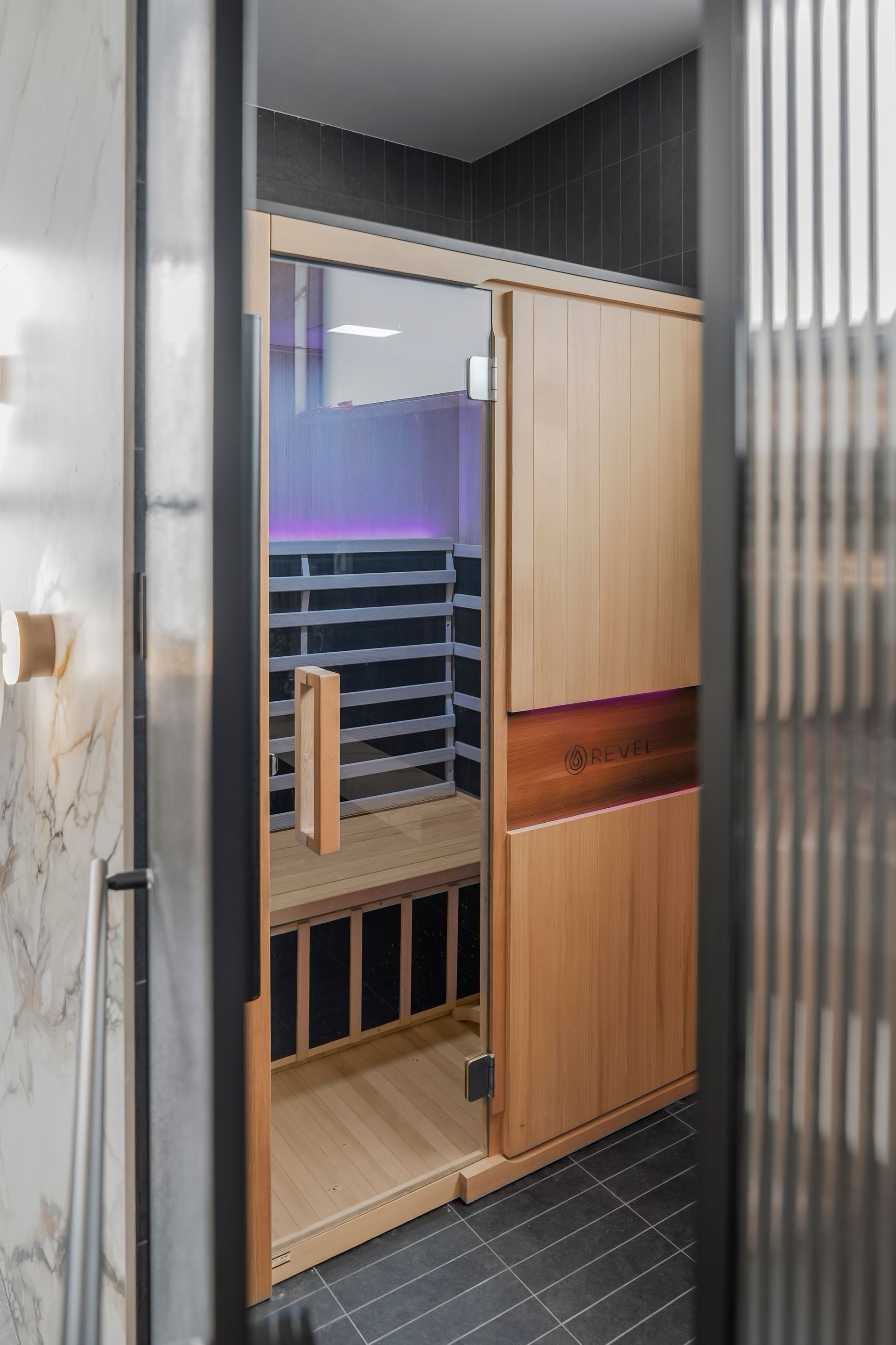 Sauna with glass door, wood paneling, and interior benches, set in a modern bathroom. — PK4 Projects in Port Macquarie, NSW
