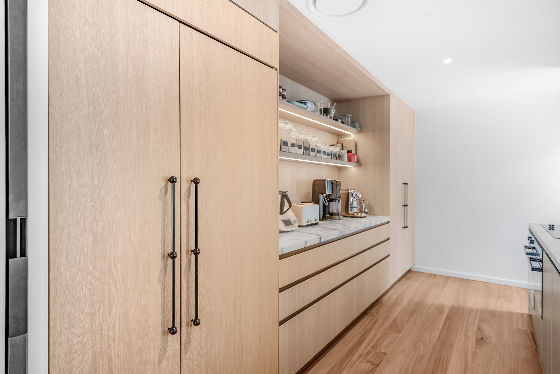 Light wood kitchen cabinets with dark handles, open shelves, and marble countertop — PK4 Projects in Port Macquarie, NSW