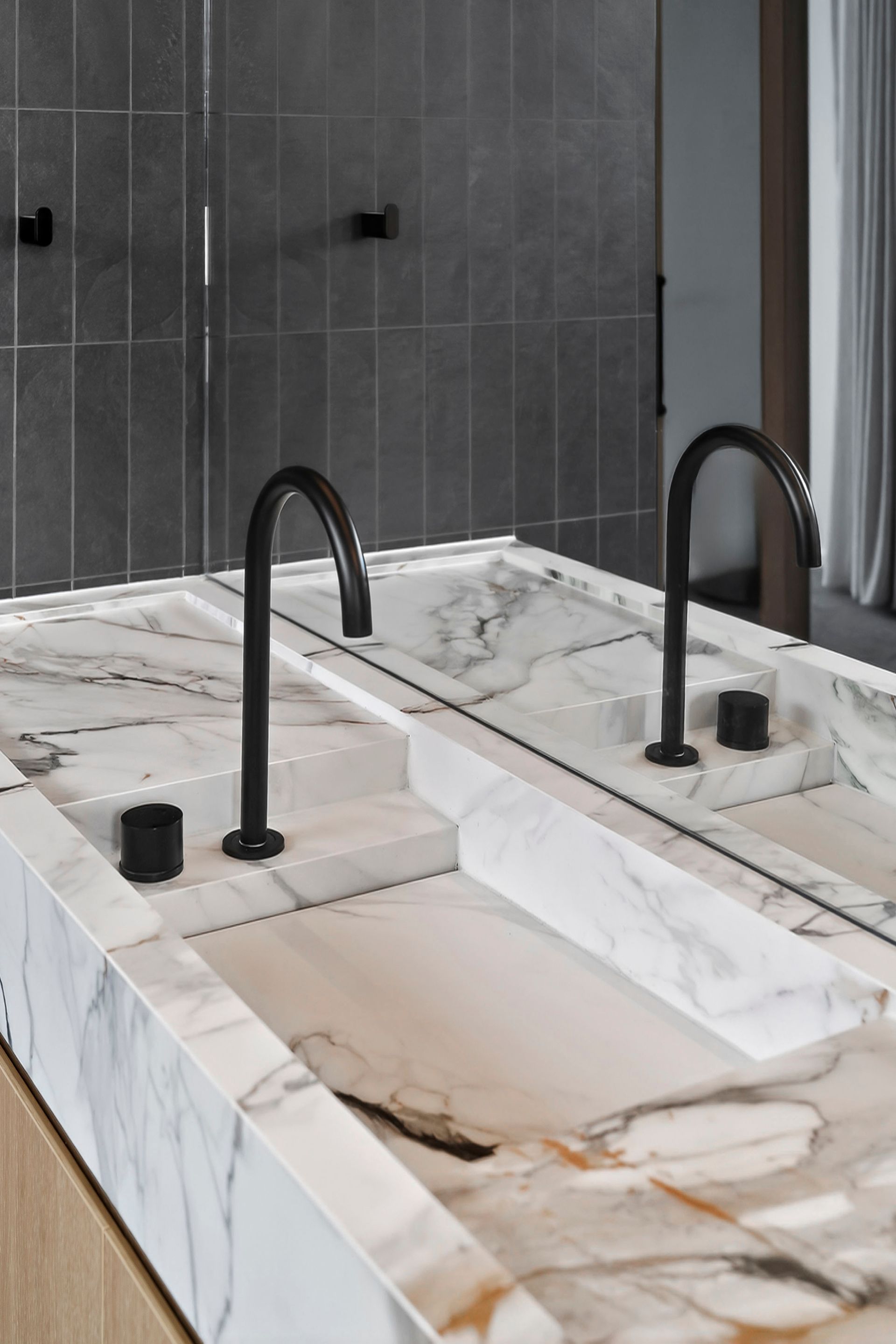 Marble countertop with two black faucets and built-in sinks in a modern bathroom  — PK4 Projects in Port Macquarie, NSW