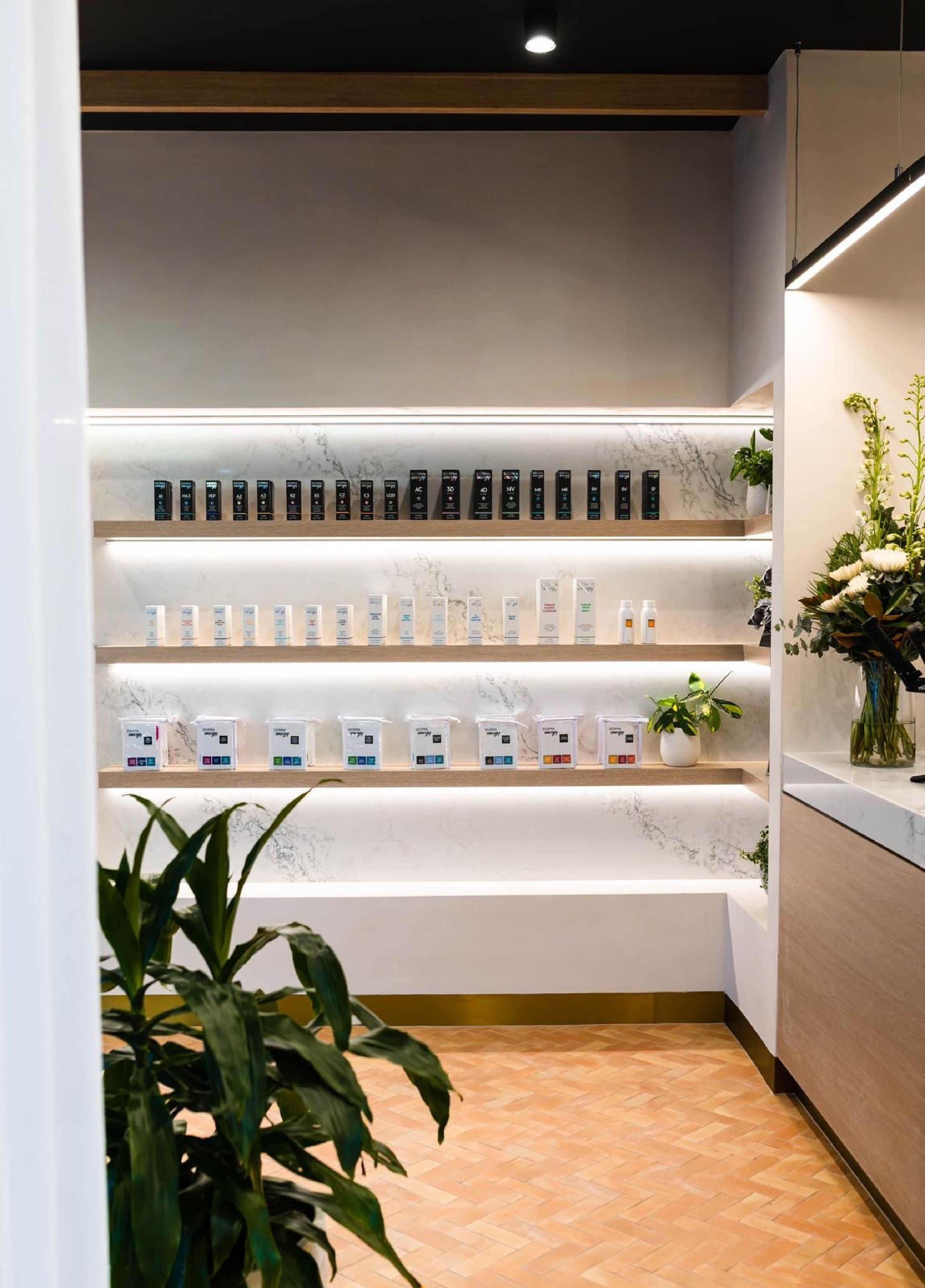 two men standing inside a glass door, one wearing a bright orange shirt — PK4 Projects in Port Macquarie, NSW