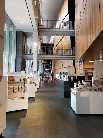 Interior shot of a museum gift shop with multiple display tables and a multi-level architectural background — PK4 Projects in Port Macquarie, NSW