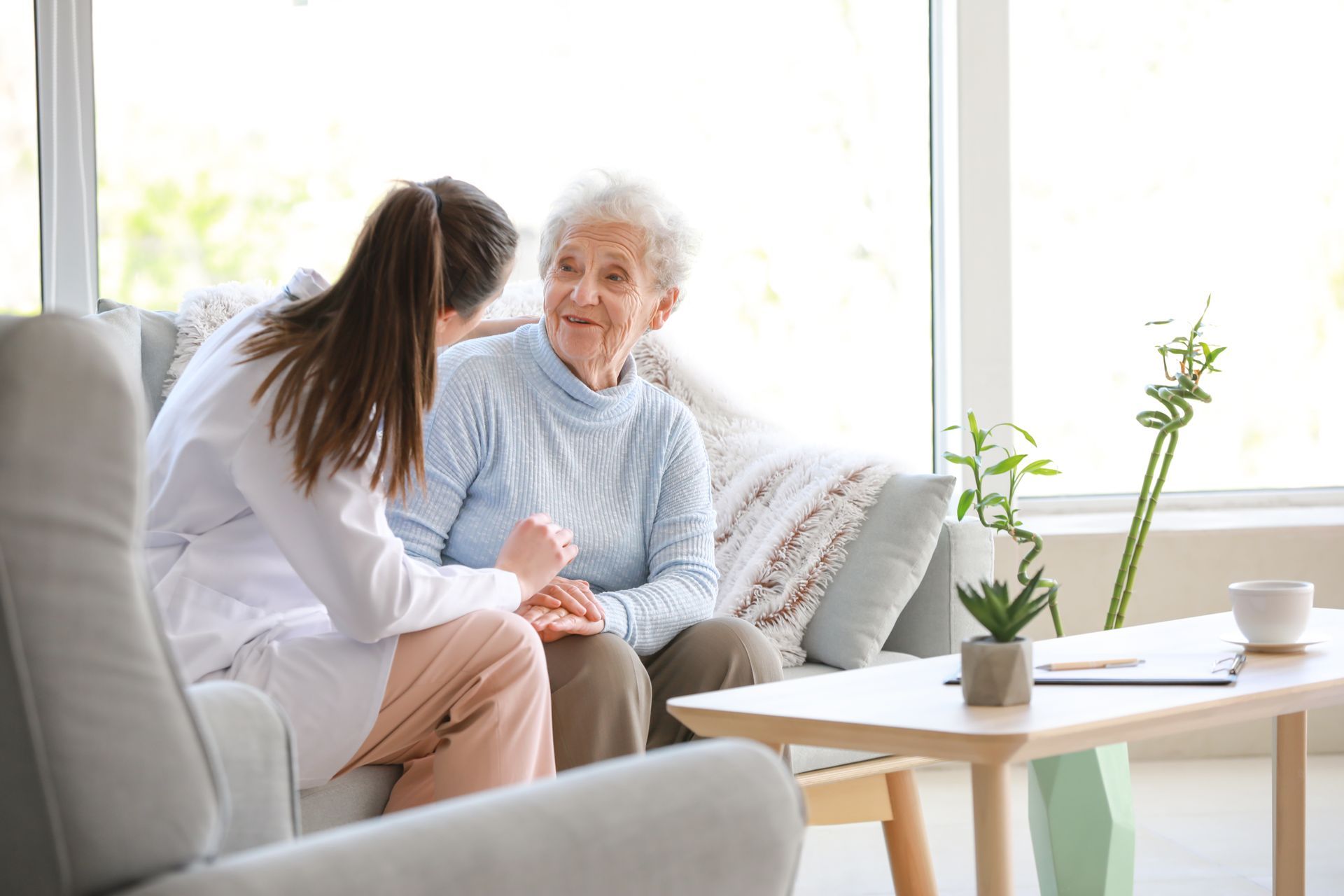 Elderly woman smiling with caregiver at home, receiving attentive home health care service. Elderly woman smiling with caregiver at home, receiving attentive home health care service.