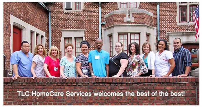 Staff of TLC HomeCare Services smiling in front of a brick building.