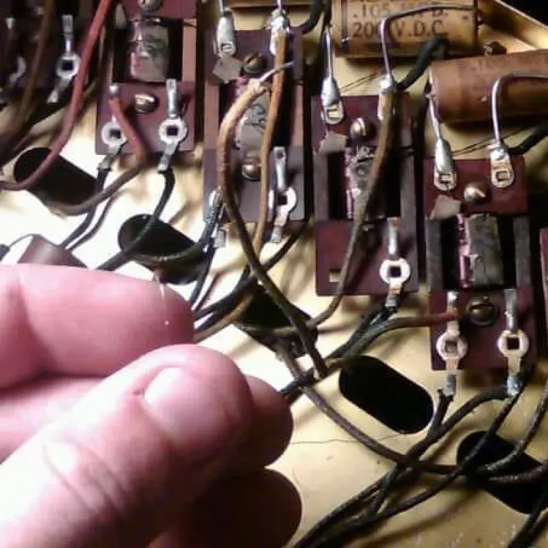 A close up of a person 's hand holding a piece of electrical equipment