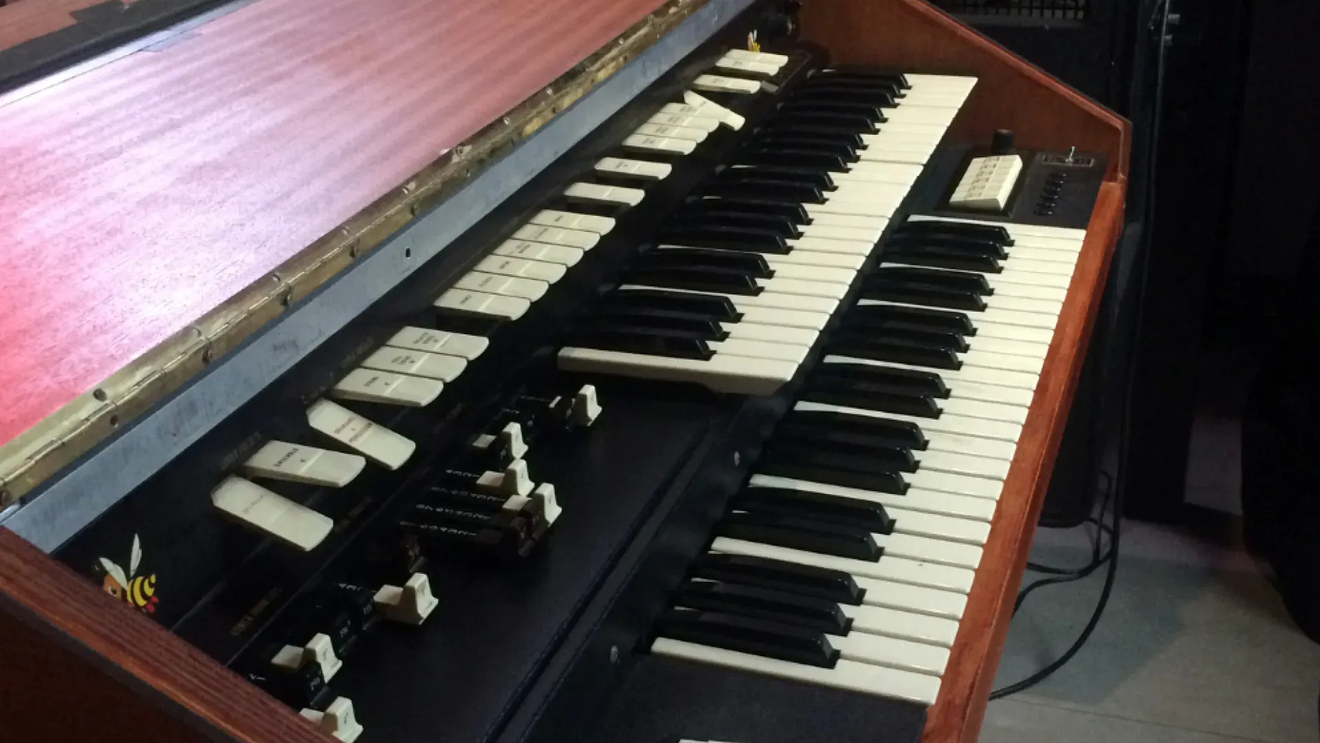 A close up of a piano keyboard with a red top
