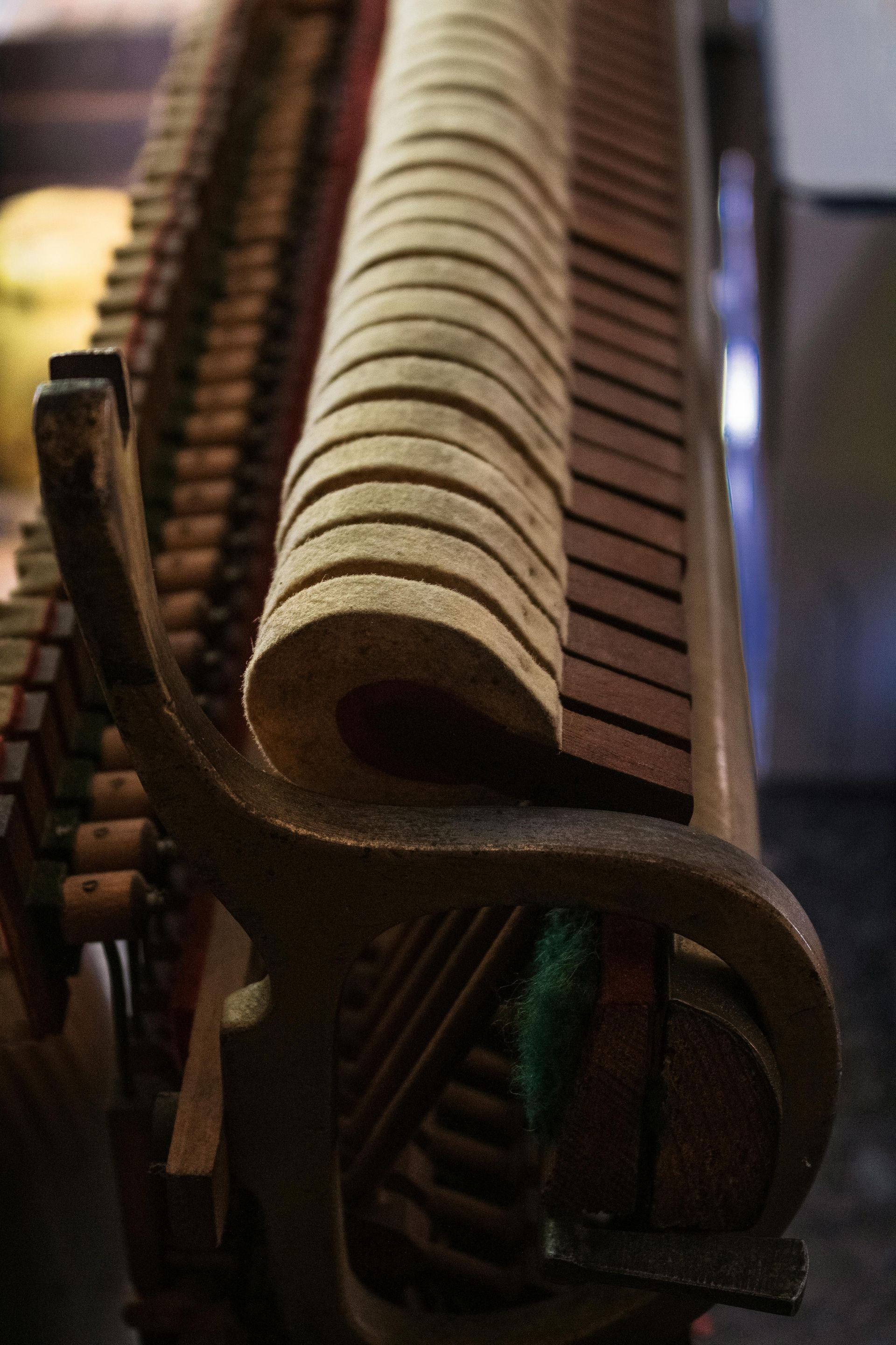 A close up of the inside of an upright piano