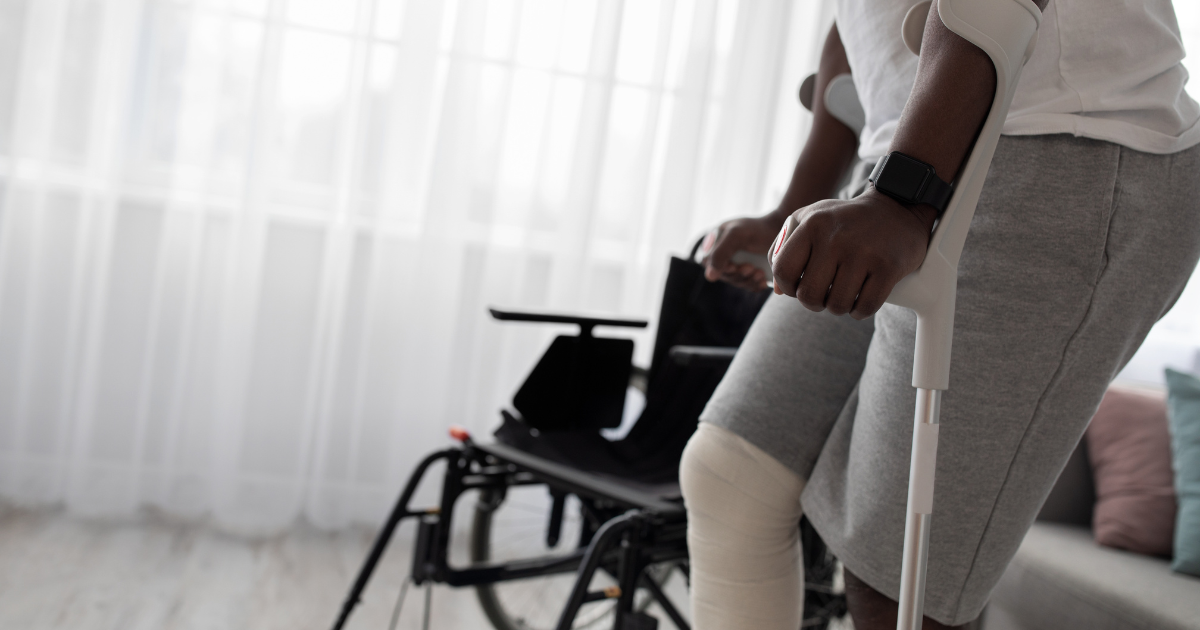 Person on crutches recovering from knee surgery with stem cell therapy support