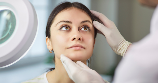 Female patient receiving facial evaluation during stem cell therapy consultation in Las Vegas for na