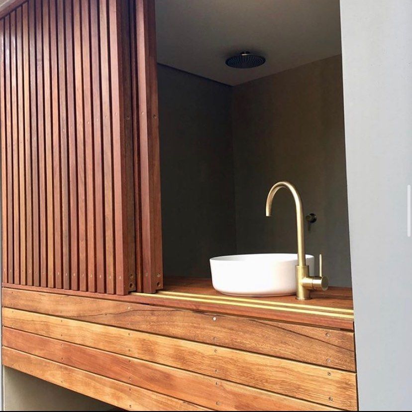 A White Sink With A Gold Tap Sitting On A Wooden Frame  — Sampson Plumbing Pty Ltd In Casuarina, NSW