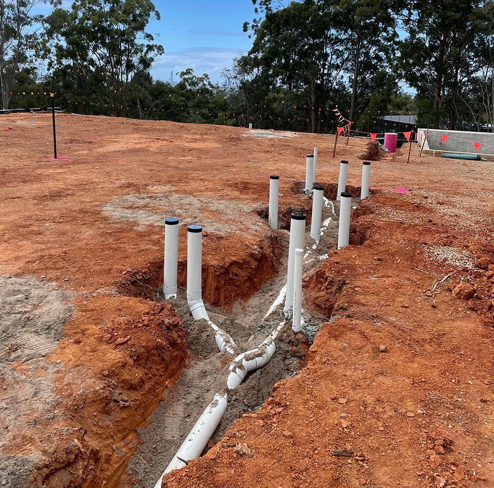 Construction Site Trench With White Plumbing Pipes — Sampson Plumbing Pty Ltd In Burleigh Heads, QLD