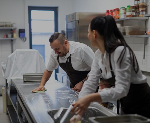 Cleaning a Stainless Steel Table — Bakery Equipment in Port Macquarie, NSW