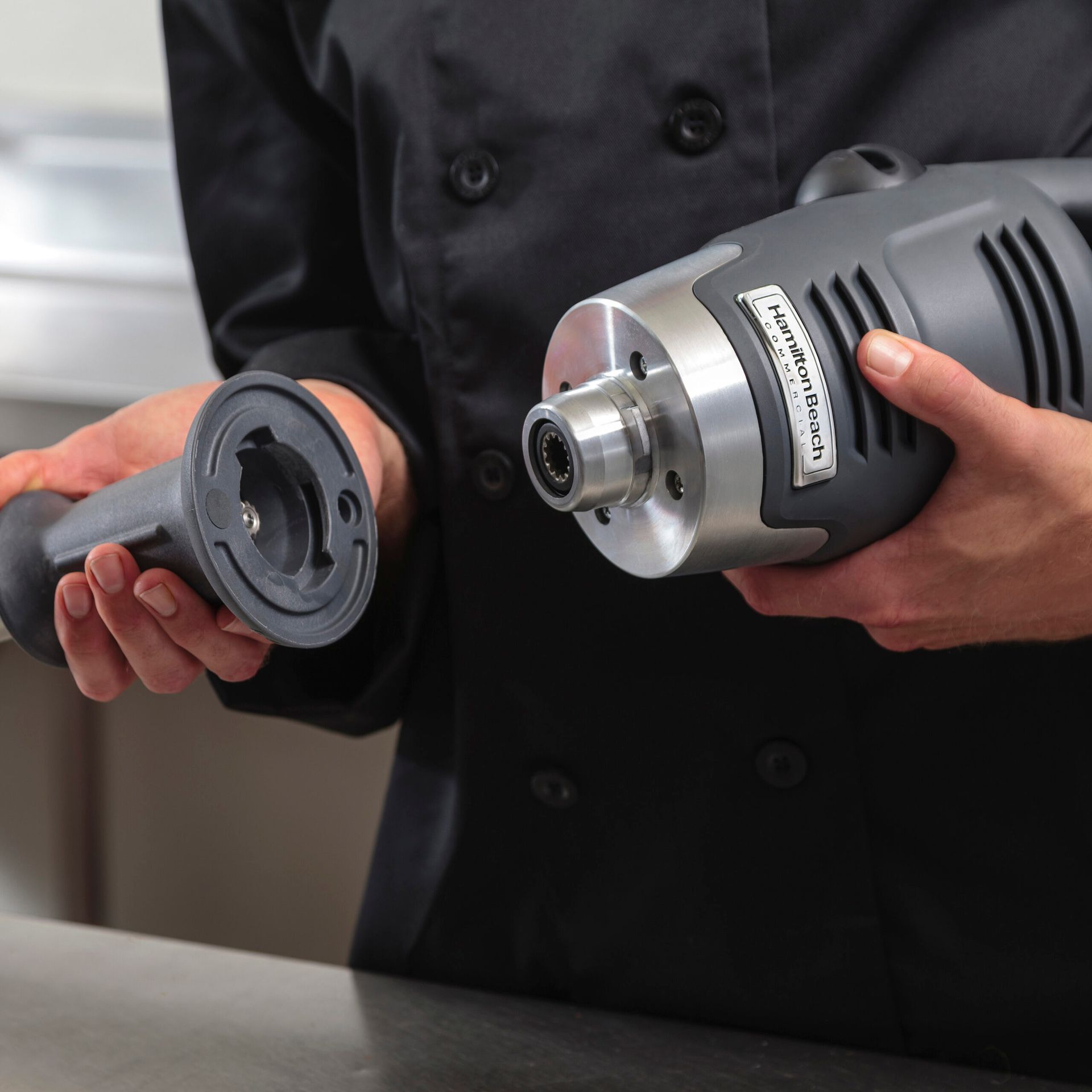 A blender with a yellow cord attached to it on a white background.