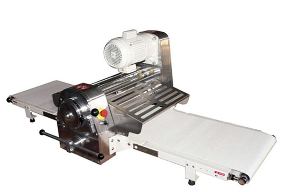 A machine is sitting on a conveyor belt on a white background.