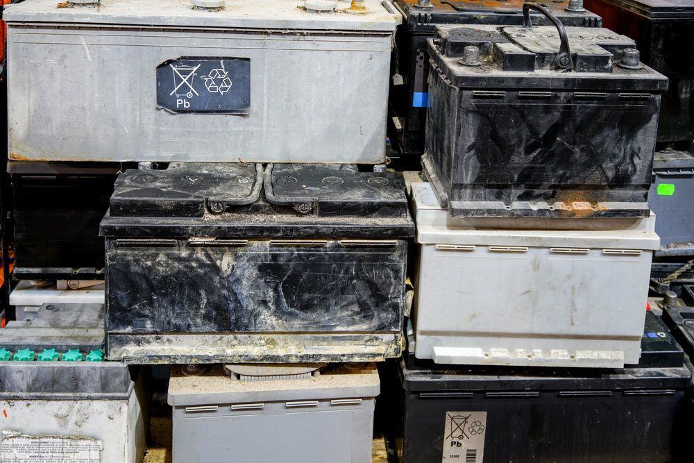 A Pile of Old Batteries Are Stacked on Top of Each Other  — Bakers Creek Wreckers In Emu Park, QLD