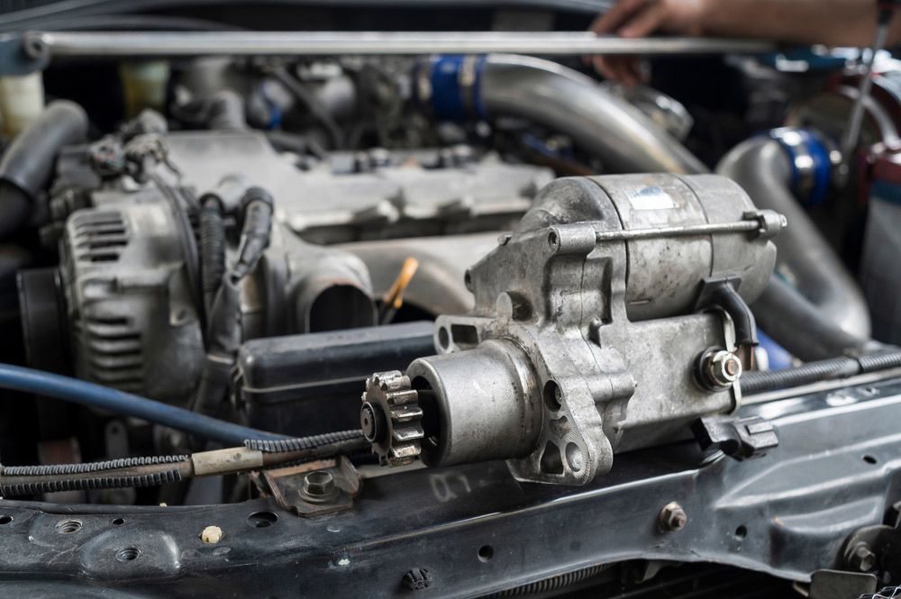 A Person Is Working on The Engine of A Car  — Bakers Creek Wreckers In Emu Park, QLD