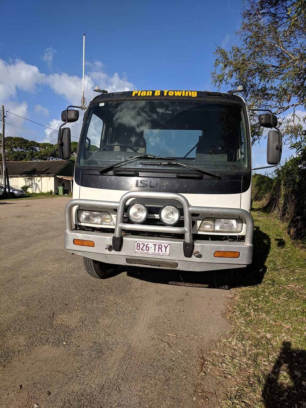 A Truck Is Parked on The Side of A Dirt Road — Bakers Creek Wreckers In Bakers Creek, QLD