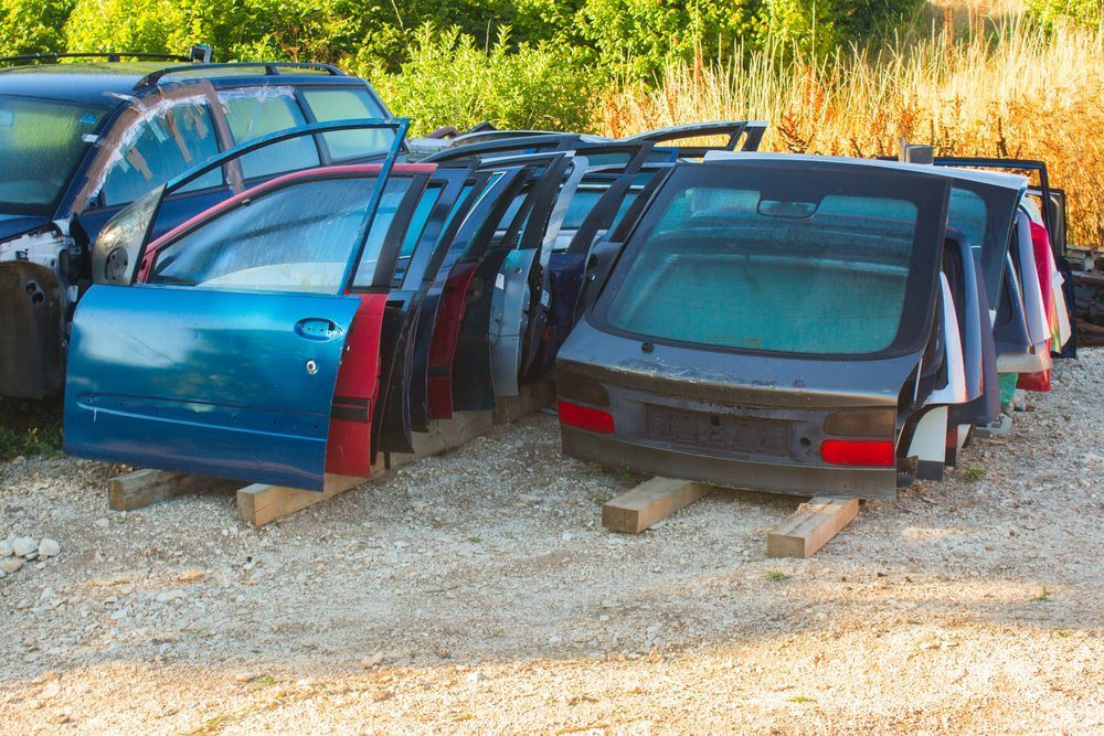 A Bunch of Car Doors Are Sitting — Bakers Creek Wreckers In Gracemere, QLD