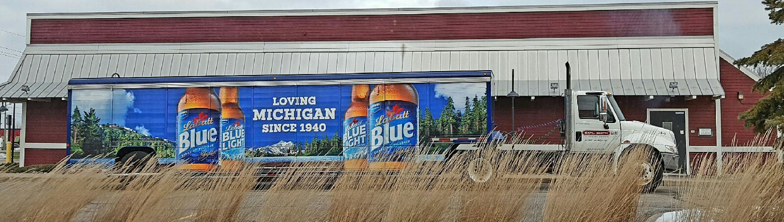 A building with a painting on the side that says blue ribbon