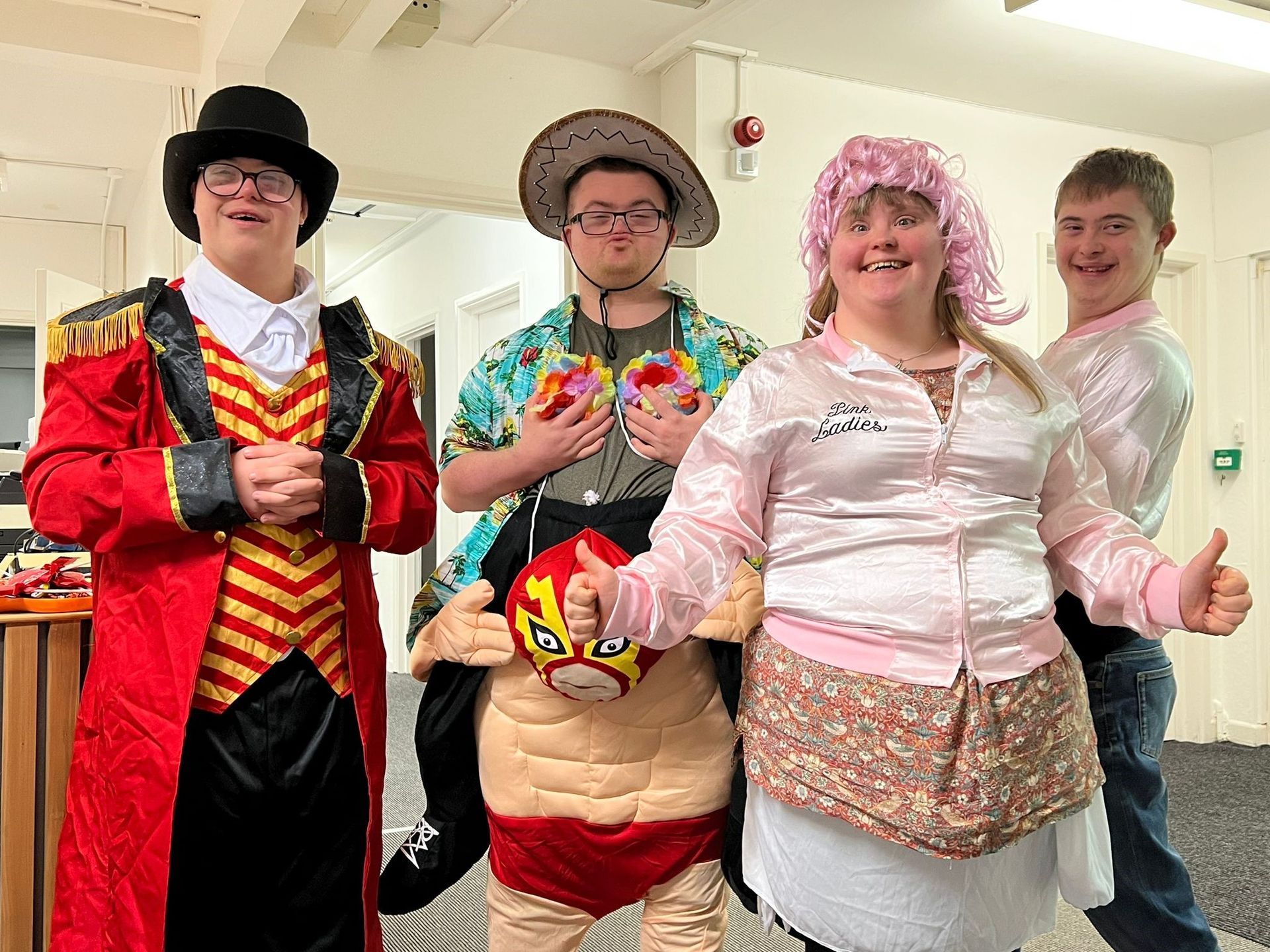 a group of people dressed in costumes are posing for a picture .