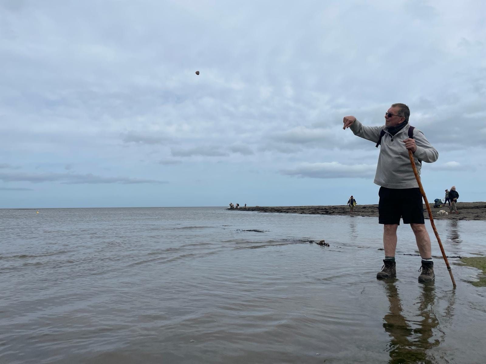 man throwing a stone into the sea.  Supporting Down Syndrome Cheshire
