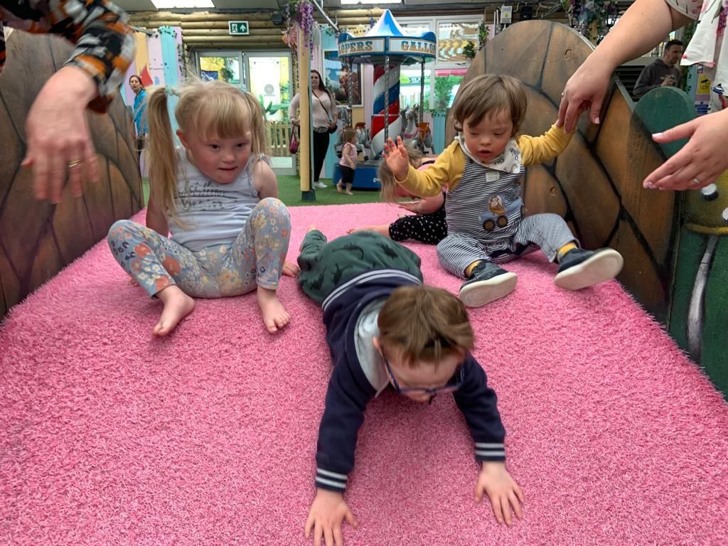 Young children with Down syndrome playing in soft play area Down Syndrome Cheshire