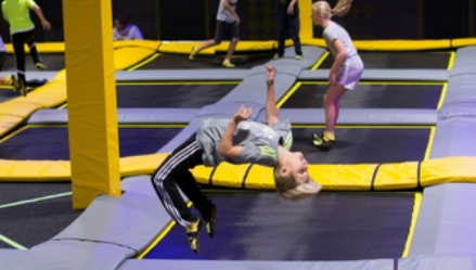 a girl is doing a flip on a trampoline .