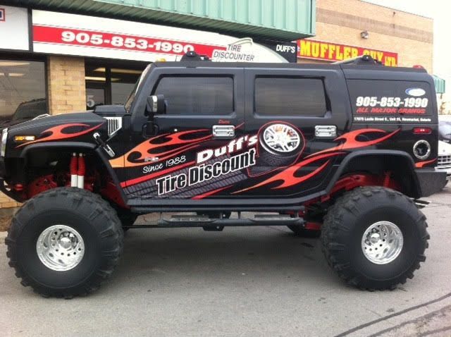 A puff 's tire discount truck is parked in front of a building
