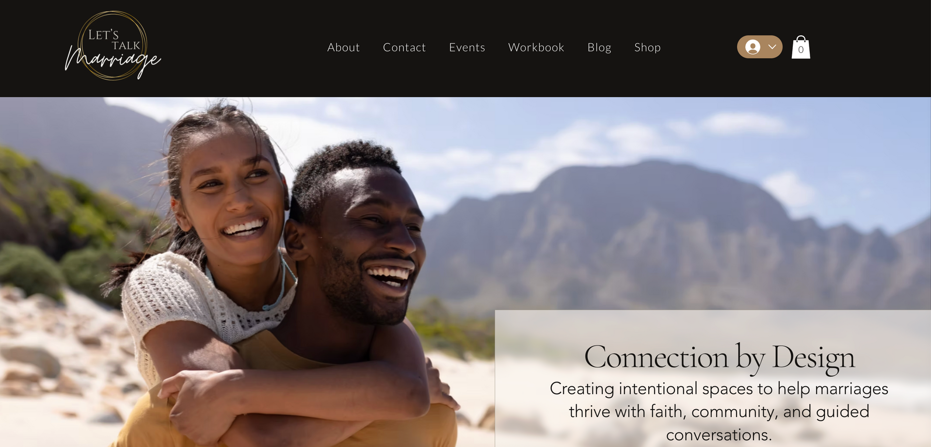 Smiling Black couple, with the woman hugging the man, on a beach in front of mountains.