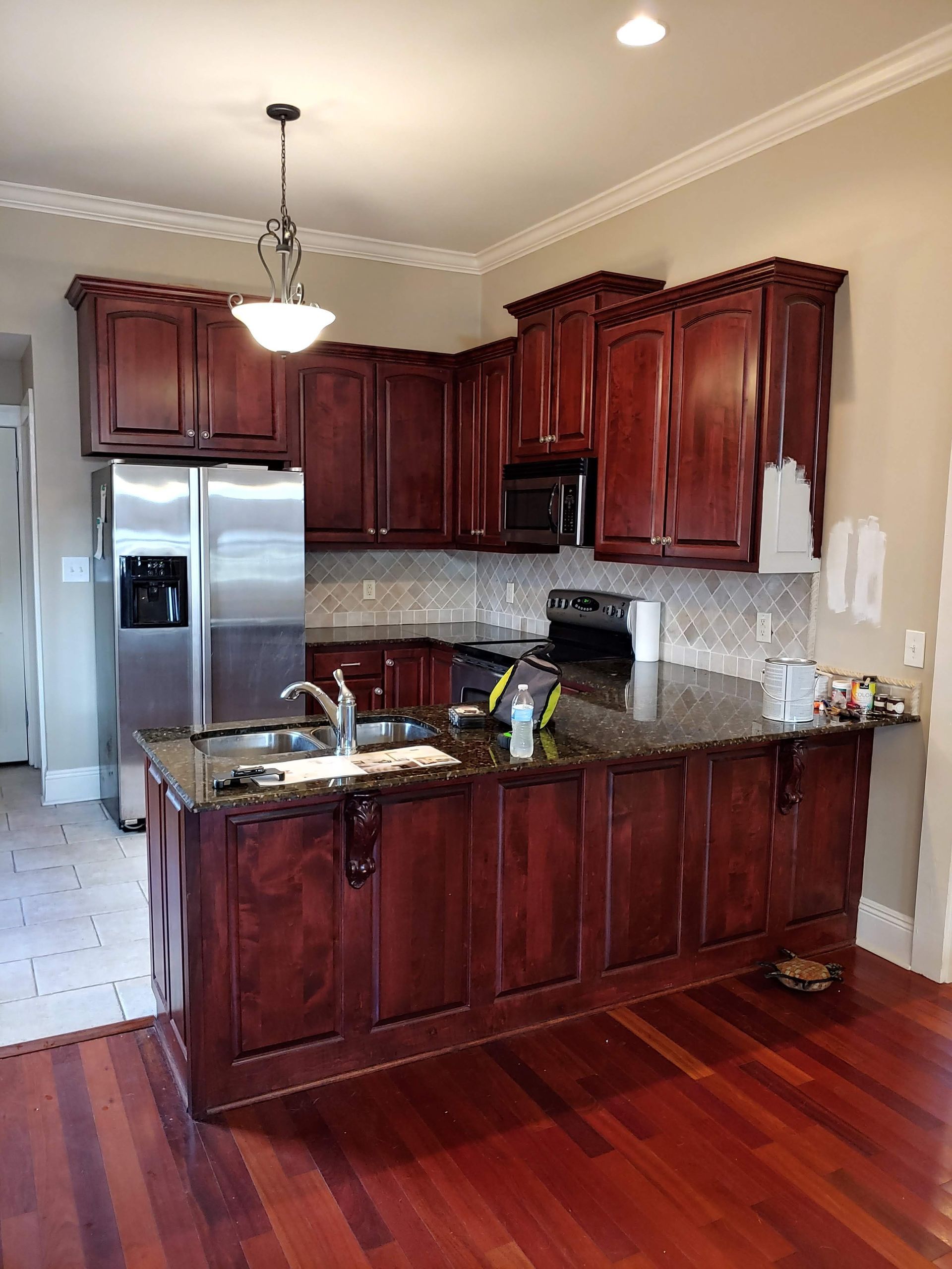 A kitchen with stainless steel appliances and wooden cabinets