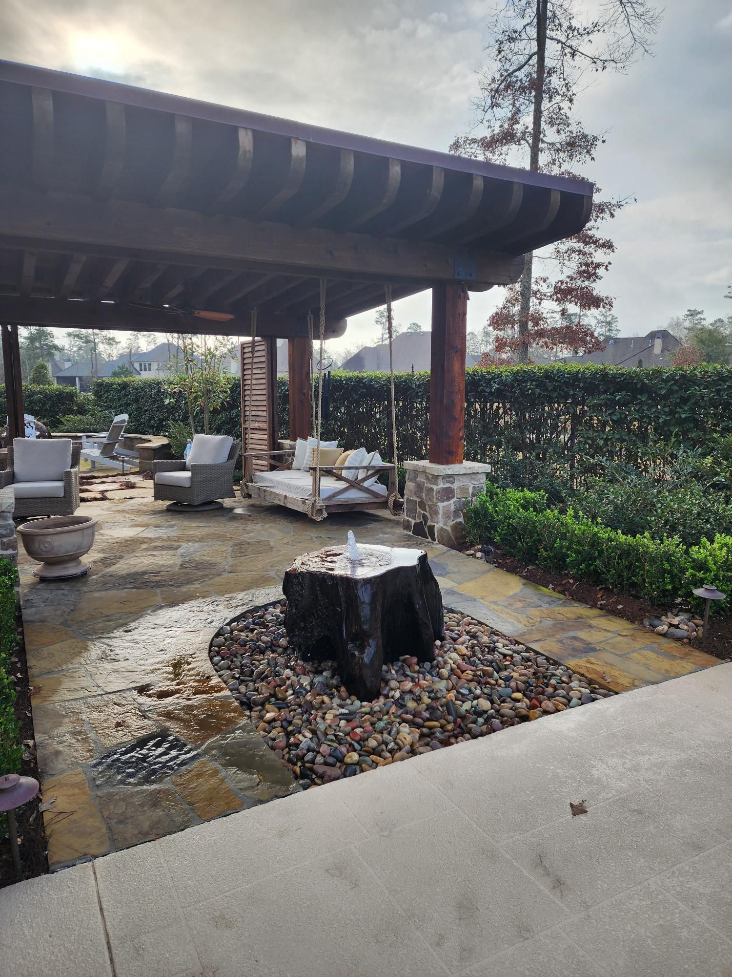A patio with a table and chairs under a pergola.