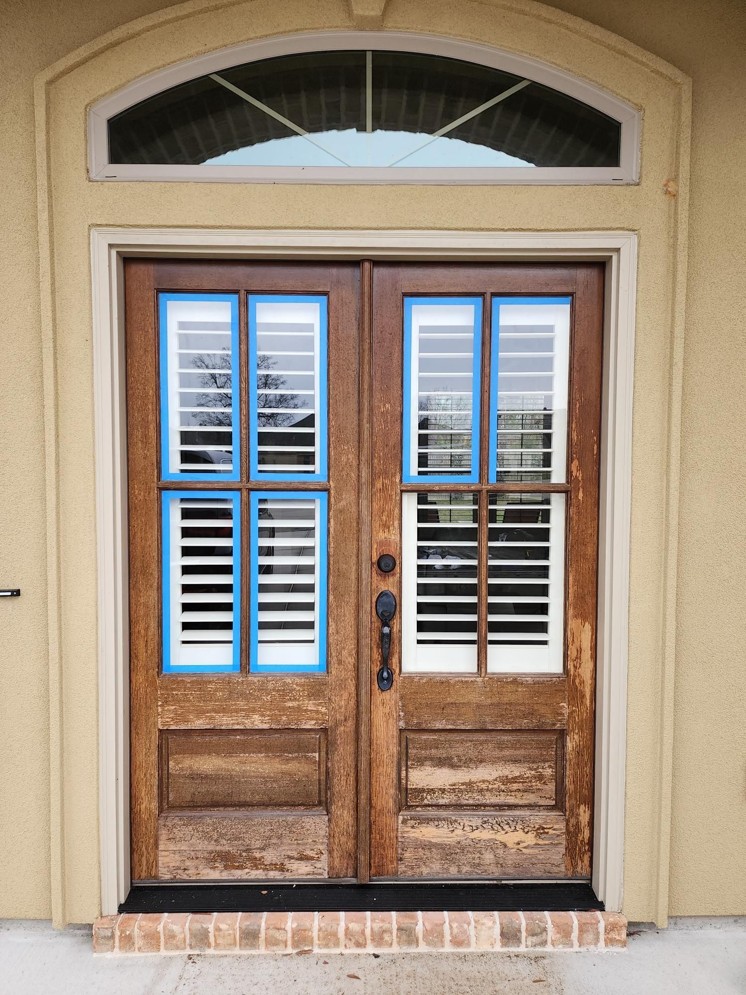 A brown door with white shutters on it