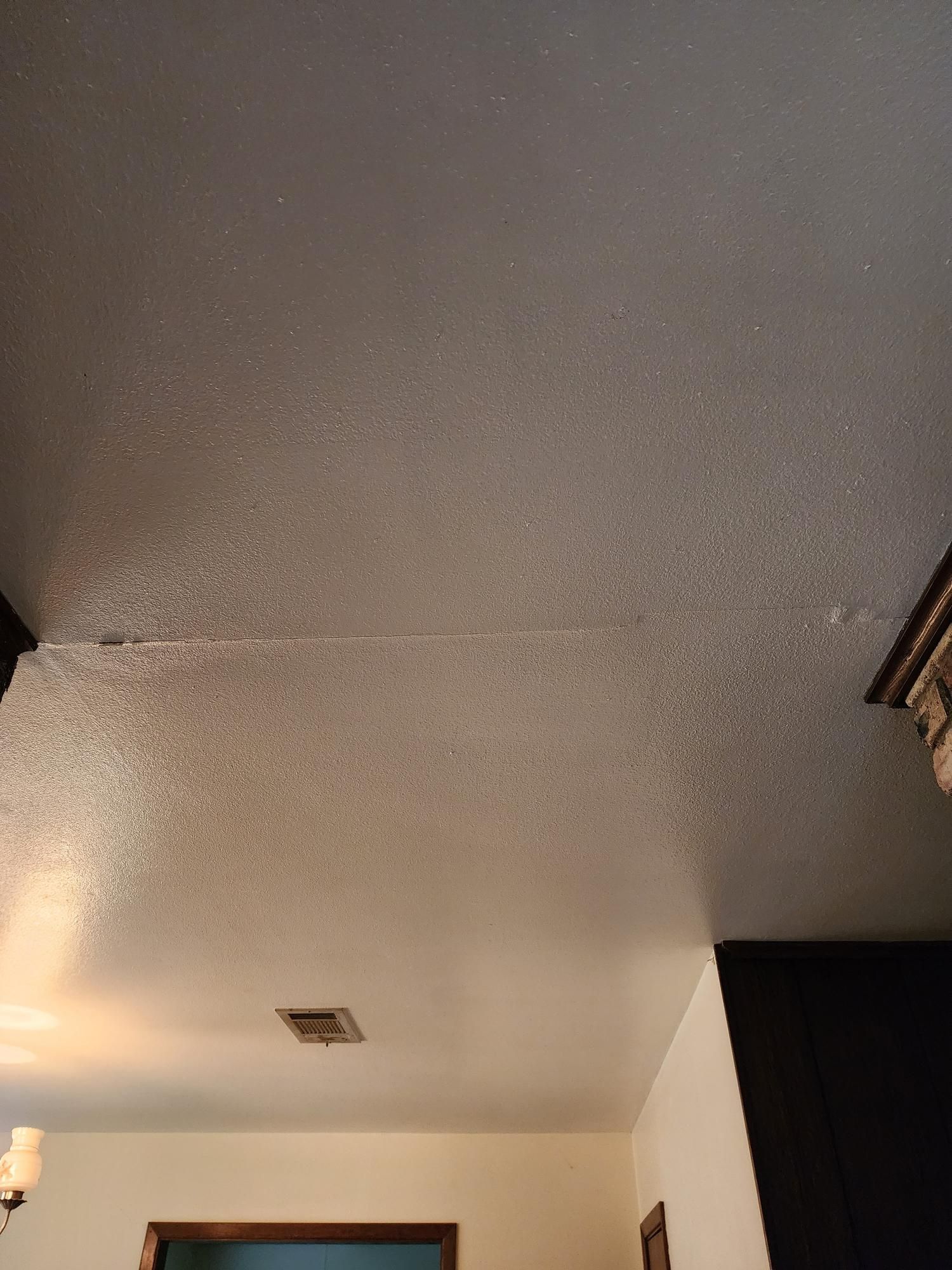 A white ceiling in a room with a light on it.