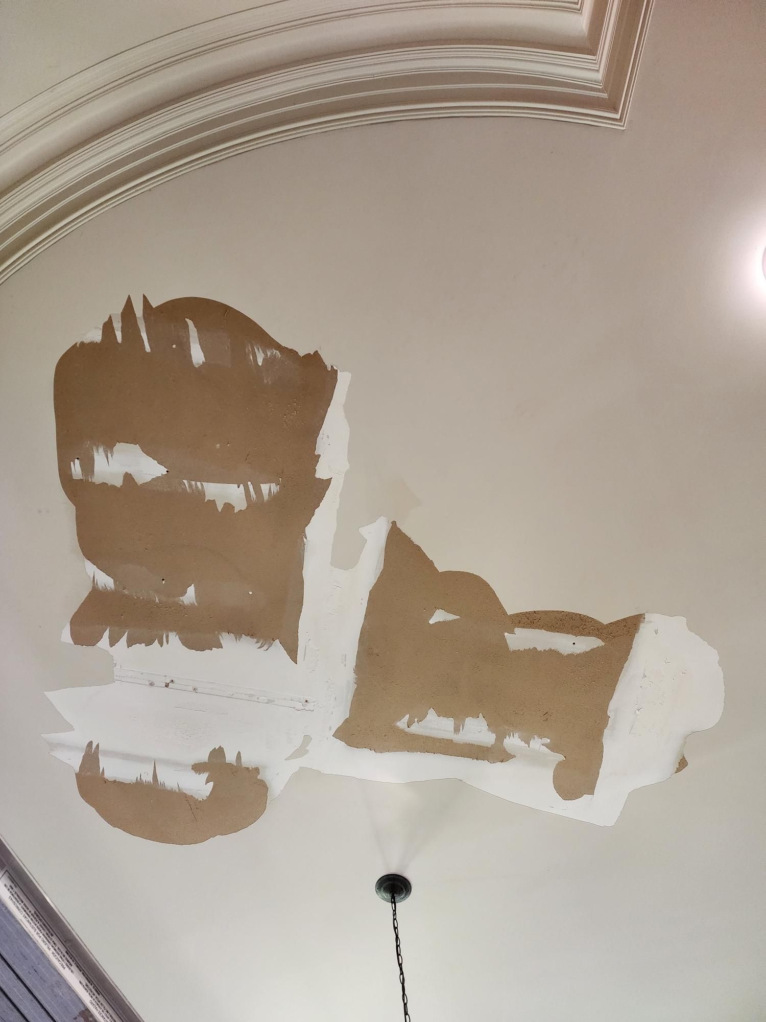 A ceiling with a few pieces of paper on it