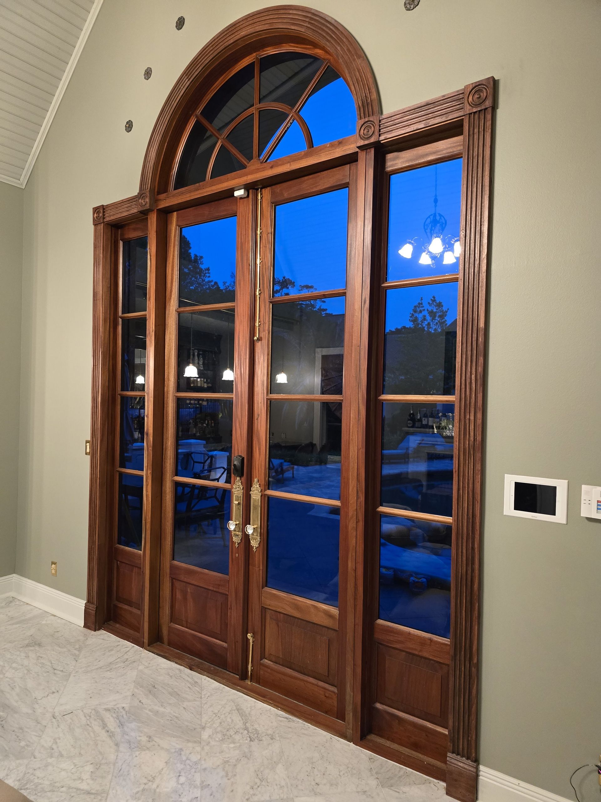 A large wooden door with a blue sky behind it