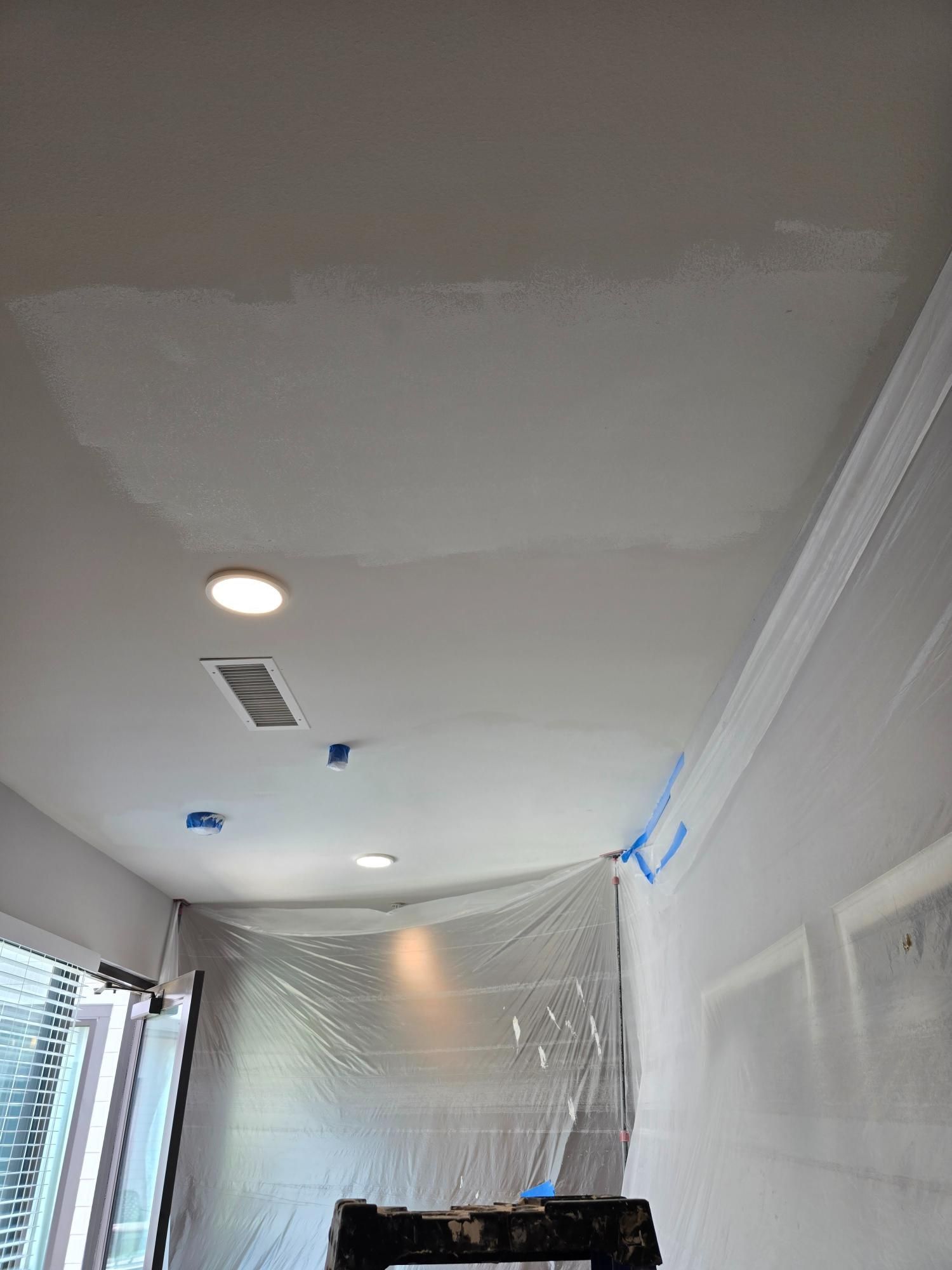 A room with a ceiling that is covered in plastic.