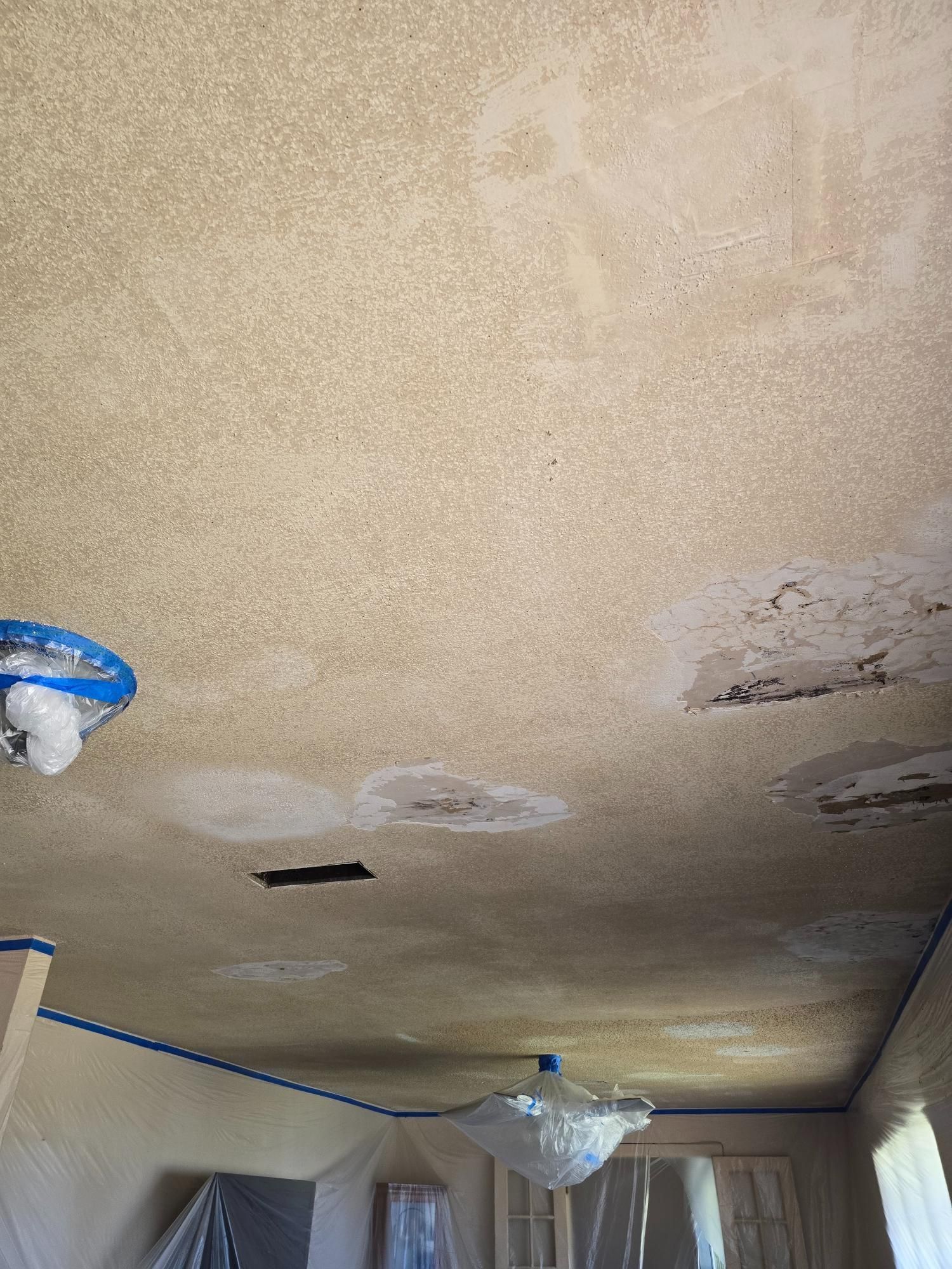 A room with a ceiling that is being painted.